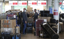 People check in luggages at the Vaclav Havel airport after a Russian special government plane landed in Prague, Czech Republic, Monday, April 19, 2021. Czech Republic is expelling 18 diplomats identified as spies over a 2014 ammunition depot explosion. On Saturday, April 17, 2021, Prime Minister Andrej Babis said the Czech spy agencies provided clear evidence about the involvement of Russian military agents in the massive explosion that killed two people. (AP Photo/Petr David Josek)