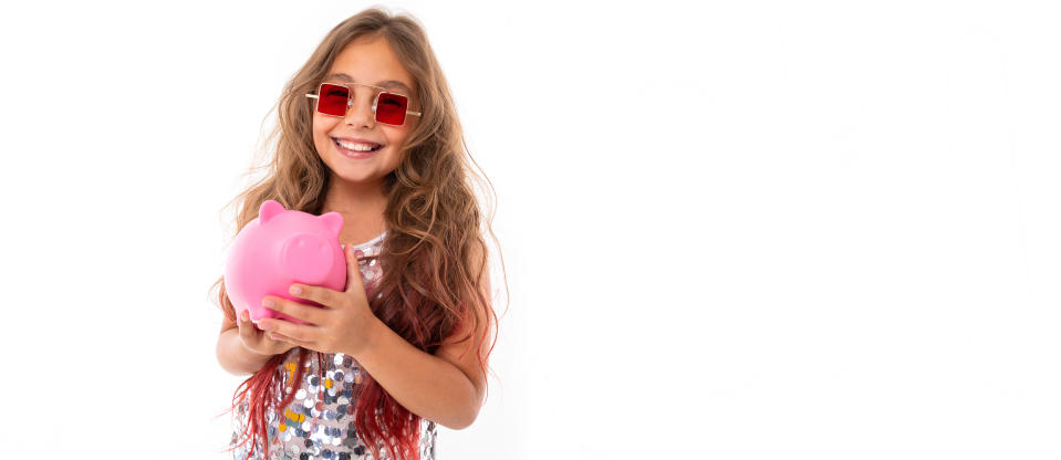 Little pretty caucasian girl with pink pig mobeybox, panorama isolated on white background.