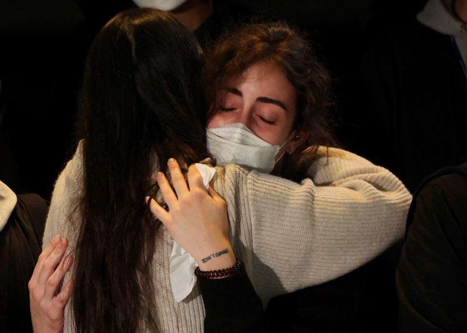 People comfort each other as they grieve those lost in the stampede (REUTERS)