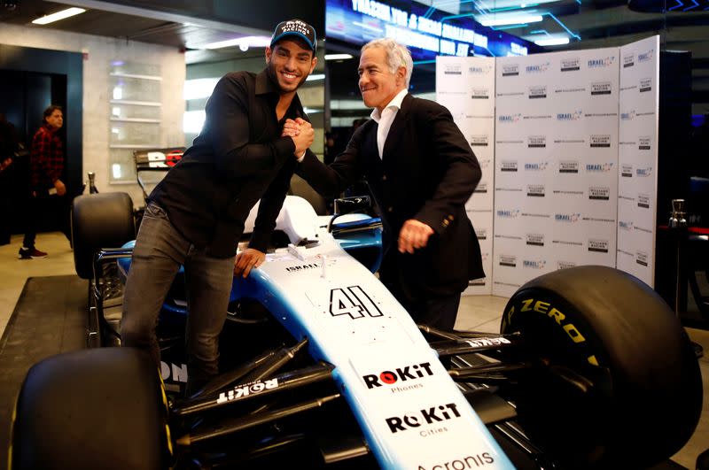 Israeli racing driver Roy Nissany and Sylvan Adams pose for a photo after Nissany signed with British Formula One motor racing team Williams in Tel Aviv