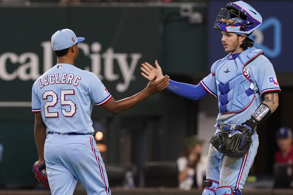 Texas Rangers closer Jose Leclerc (25) is congratulated by teammate catcher Jonah Heim after logging the final strike to end a baseball game against the Toronto Blue Jays in Arlington, Texas, Sunday, Sept. 11, 2022. (AP Photo/LM Otero)