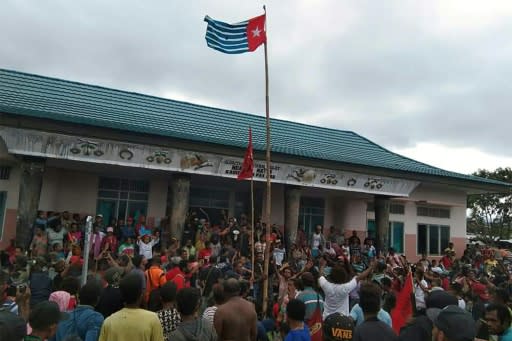 Protesters gather under the banned Papuan flag in the city of Fakfak