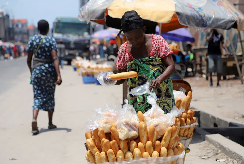 FILE PHOTO: A Congolese woman arranges bread for sale at an open air market, amid concerns about the spread of coronavirus disease (COVID-19) in Kinshasa