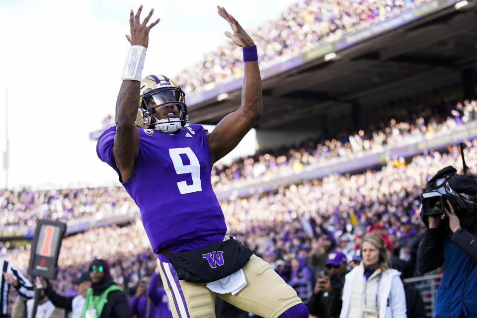 FILE - Washington quarterback Michael Penix Jr. reacts after scoring a touchdown against Utah during the first half of an NCAA college football game Saturday, Nov. 11, 2023, in Seattle. Penix is a finalists for the Heisman Trophy. (AP Photo/Lindsey Wasson, File)