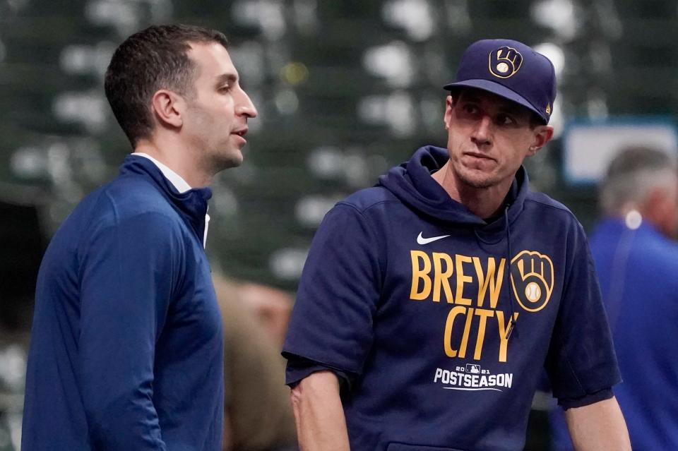 Milwaukee Brewers manager Craig Counsell talks to general manager David Stearns at a practice for the Game 1 of the NLDS baseball game Thursday, Oct. 7, 2021, in Milwaukee. The Brewers plays the Atlanta Braves in Game 1 on Friday, Oct. 8, 2021.