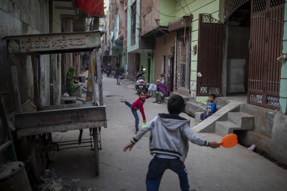 Children play in an alleyway in North Ghonda neighborhood, one of the worst riot affected area during the February 2020 communal riots, in New Delhi, India, Friday, Feb. 19, 2021. As the first anniversary of bloody communal riots that convulsed the Indian capital approaches, Muslim victims are still shaken and struggling to make sense of their struggle to seek justice. (AP Photo/Altaf Qadri)