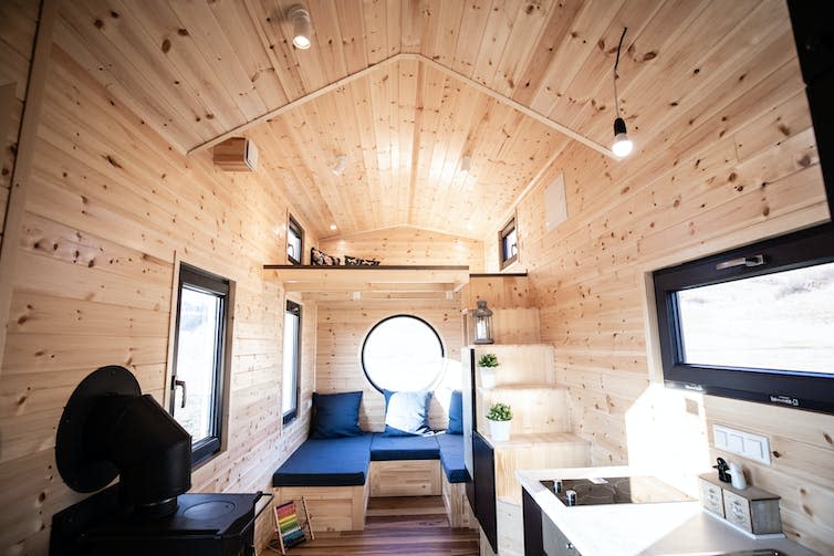 A wood-panelled interior of a small house.