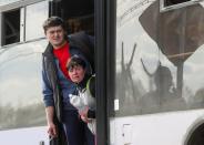 Civilians who left the area near Azovstal steel plant in Mariupol look out of a bus near a temporary accommodation centre in Bezimenne