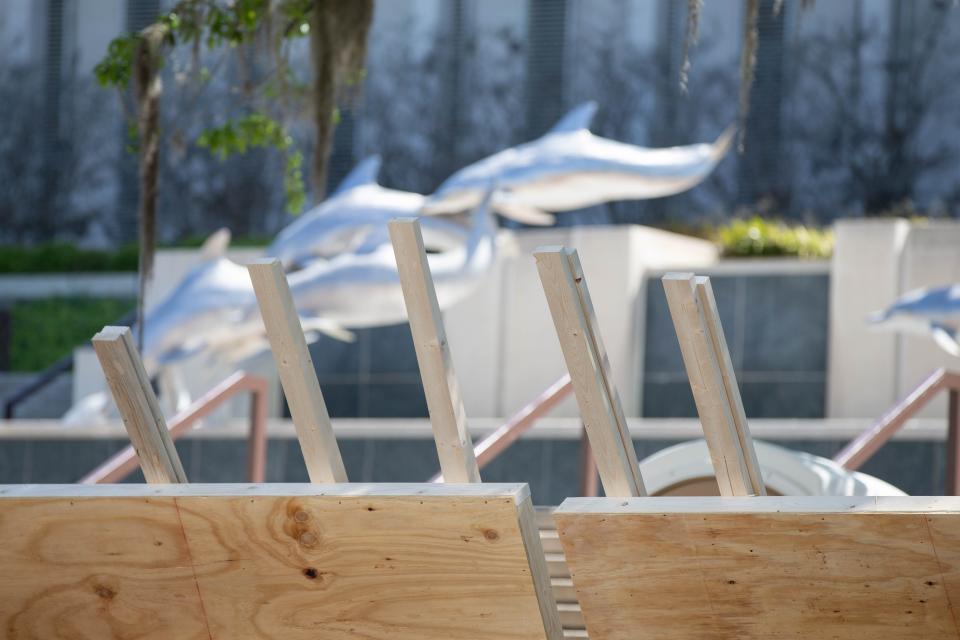 A construction crew works to build a barrier around Waller Park on the Florida Capitol Complex's west side as a construction project begins there Tuesday, April 6, 2021.