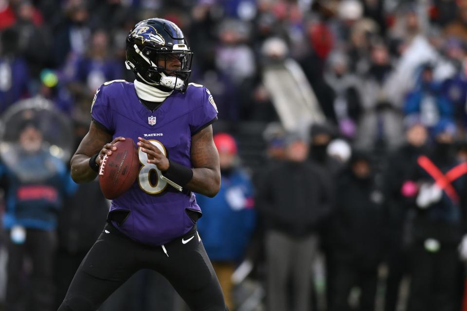 Baltimore Ravens quarterback Lamar Jackson drops back to throw against the Houston Texans in the first quarter of their divisional round matchup.