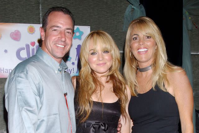 <p>Bill Davila/FilmMagic</p> Lindsay Lohan with her father Michael Lohan and mother Dina Lohan.