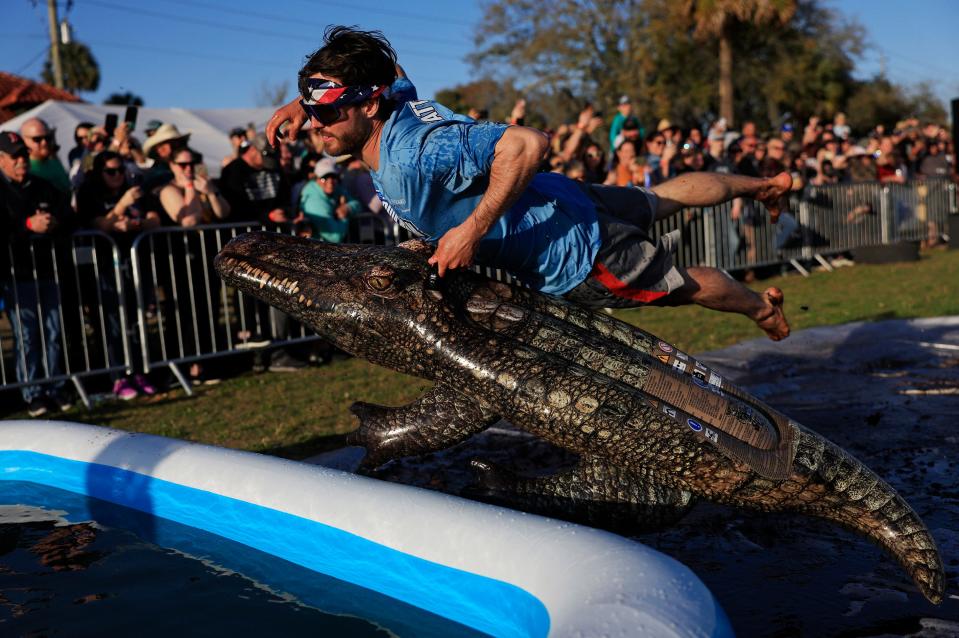 Ben Green of St. Augustine flies into the pool on his inflatable alligator to find the hidden lizard at the bottom of the pool in the “Evading Arrest Obstacle Course” during the inaugural Florida Man Games Saturday, Feb. 24, 2024 at Francis Field in St. Augustine, Fla. Hundreds turned out to witness the Floridian Olympic-style events. Team “Hanky Spanky,” based out of St. Augustine, would take home the championship belt. [Corey Perrine/Florida Times-Union]