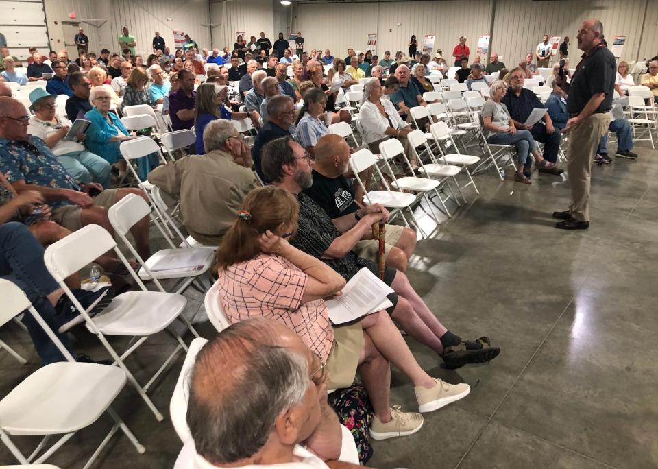 Indiana Michigan Power's director of governmental affairs, Brian Bergsma, right, talks at an open house Thursday, July 11, 2024, on the fate of the company's dams in Elkhart and Mottville, Mich., at the Northern Indiana Event Center in Elkhart.