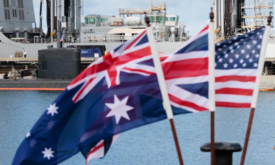 National flags of the Australia, Great Britain and the US flying at a wharf