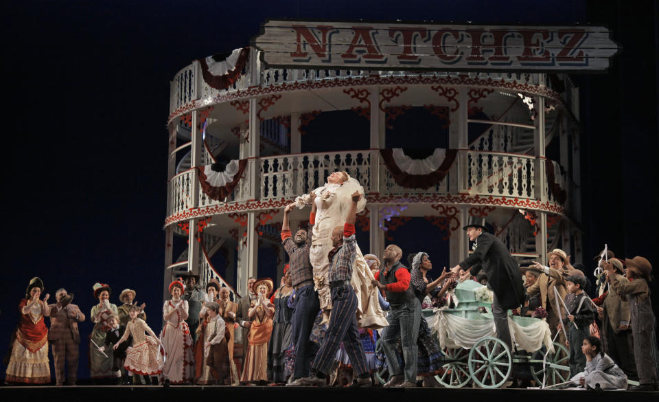 In this photo taken Feb. 9, 2012, Ashley Brown, center, portraying Magnolia Hawkes, dances with cast members in her wedding dress at a dress rehearsal during the first act of the Lyric Opera of Chicago's production of "Show Boat." (AP Photo/M. Spencer Green)