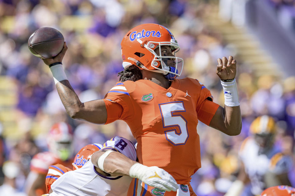 Florida quarterback Emory Jones (5) is pressured by LSU defensive end BJ Ojulari (8) in the first half of an NCAA college football game in Baton Rouge, La., Saturday, Oct. 16, 2021. (AP Photo/Matthew Hinton)