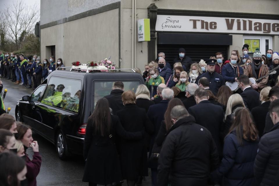 Mourners walk behind he hearse carrying the coffin as it leaves St Brigid’s Church (Damien Eagers/PA) (PA Wire)