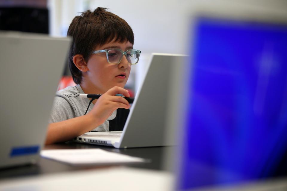 In this file photo, Edmond Magnuski, 10, is seen using one of the district's new zSpace laptops during the "Universe Reimagined" summer course, part of the STEM Out of School program. It was the first time the district has put the zSpace laptops to use, and served as a test-run ahead of their debut at the high school as part of new "neo-technical" programming this fall.