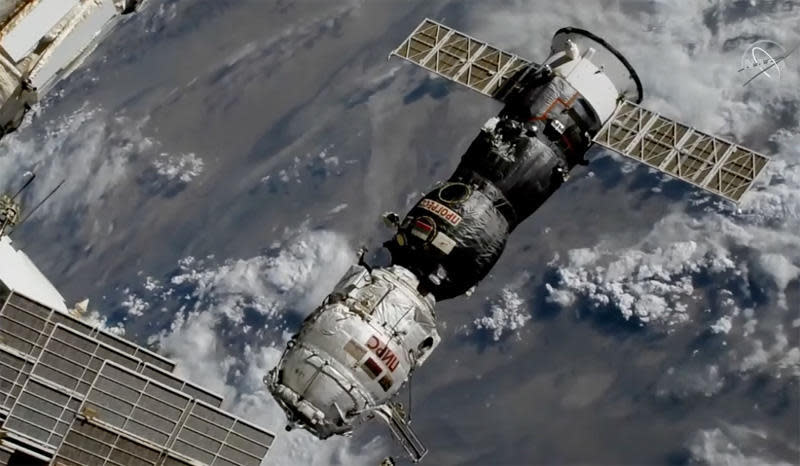 The Progress MS-16/77S cargo ship backs away from the International Space Station early on July 26, 2021, pulling the Pirs airlock and docking compartment, covered in white insulation blankets, away from the Zvezda service module. Pirs' departure clears the way for the arrival of a new Russian multipurpose laboratory module on July 29, 2021. / Credit: NASA TV