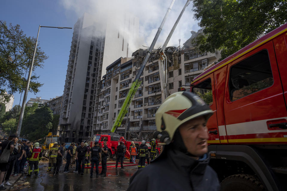 FILE - Firefighters work at the scene of a residential building following explosions, in Kyiv, Ukraine, June 26, 2022. While much of the attritional war in Ukraine’s east is hidden from sight, the brutality of Russian missile strikes in recent days on the mall in the central city of Kremenchuk and on residential buildings in the capital, Kyiv, were in full view to the world and especially to Western leaders gathered for a trio of summits in Europe. (AP Photo/Nariman El-Mofty, File)