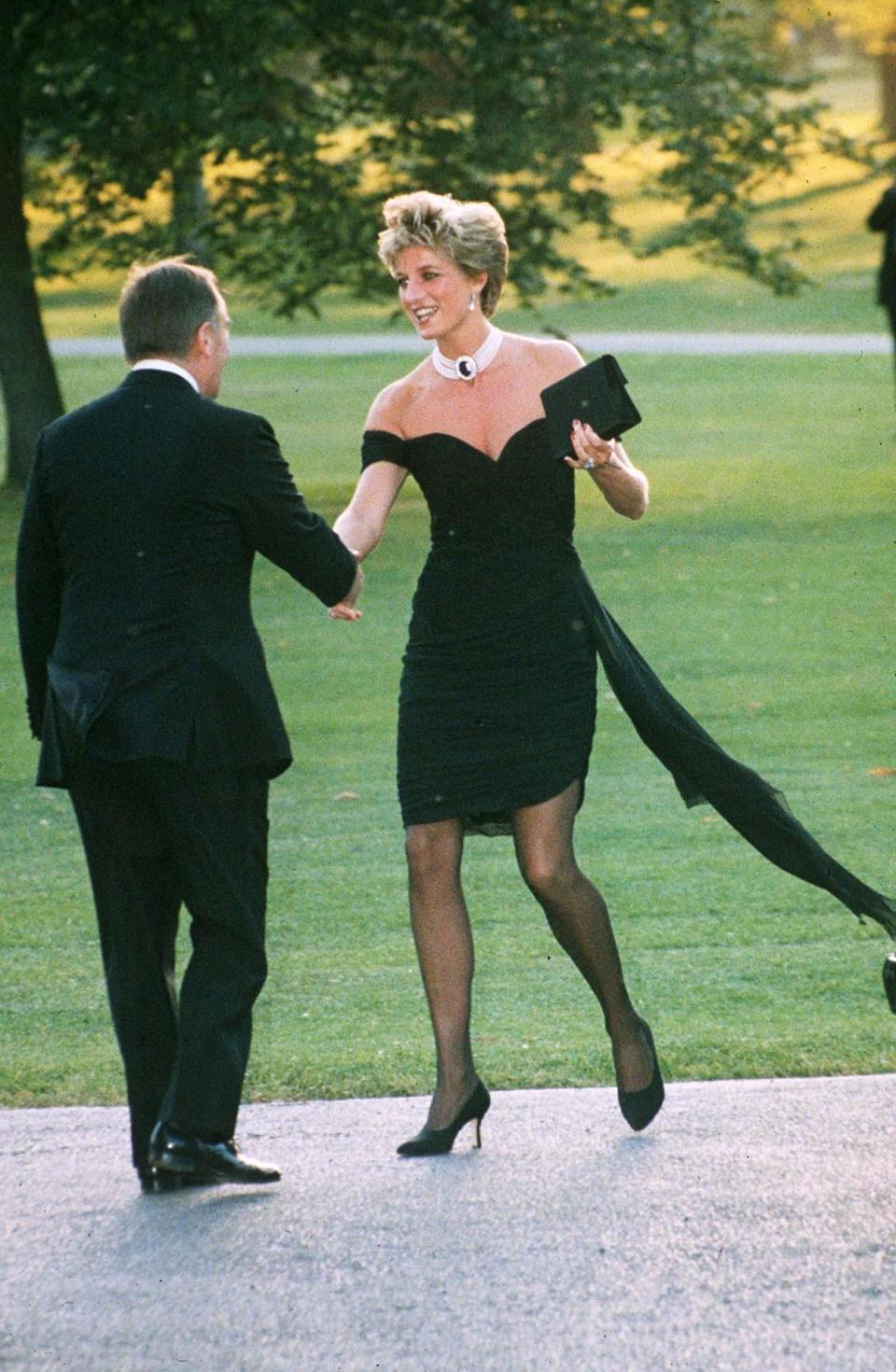 This is probably Diana’s most famous look of all time. Known as “the Revenge dress”, this black silk Christina Stambolian gown was worn by Diana to the Serpentine Gallery summer party in 1994 on the same night Prince Charles admitted to having an affair with Camilla Parker-Bowles. Diana paired the form-fitting, off-shoulder gown, with black sheer tights and stilettos. (Nils Jorgensen/Shutterstock)