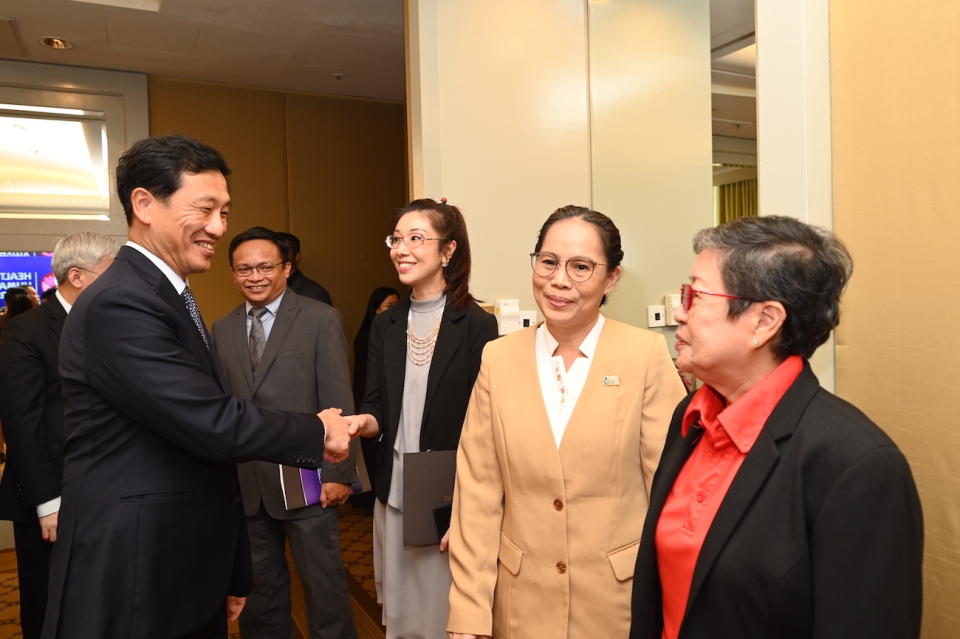 Health Minister Ong Ye Kung congratulates Dr Louisa Sun Jin and fellow award recipients.