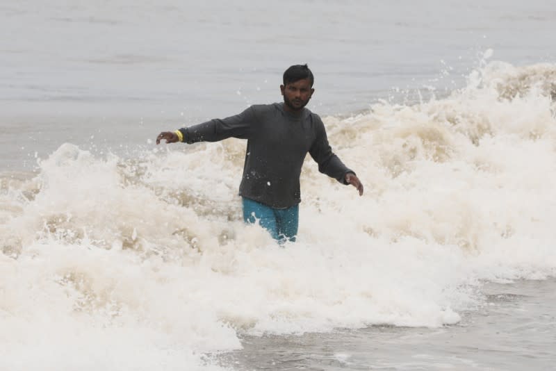 A fisherman makes his way back to the shore after anchoring his boat before cyclone Nisarga makes its landfall, in Mumbai
