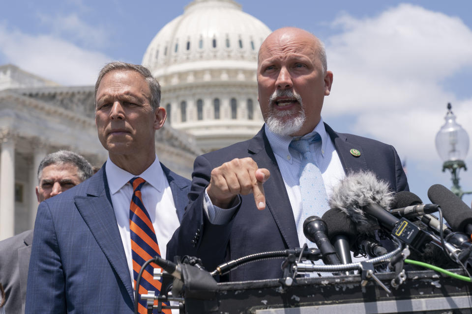 Rep. Scott Perry, R-Pa., left, and Rep. Chip Roy, R-Texas, speak with reporters as member of the conservative House Freedom Caucus talk about the debt limit deal, during a news conference, Tuesday, May 30, 2023, on Capitol Hill in Washington. (AP Photo/Jacquelyn Martin)