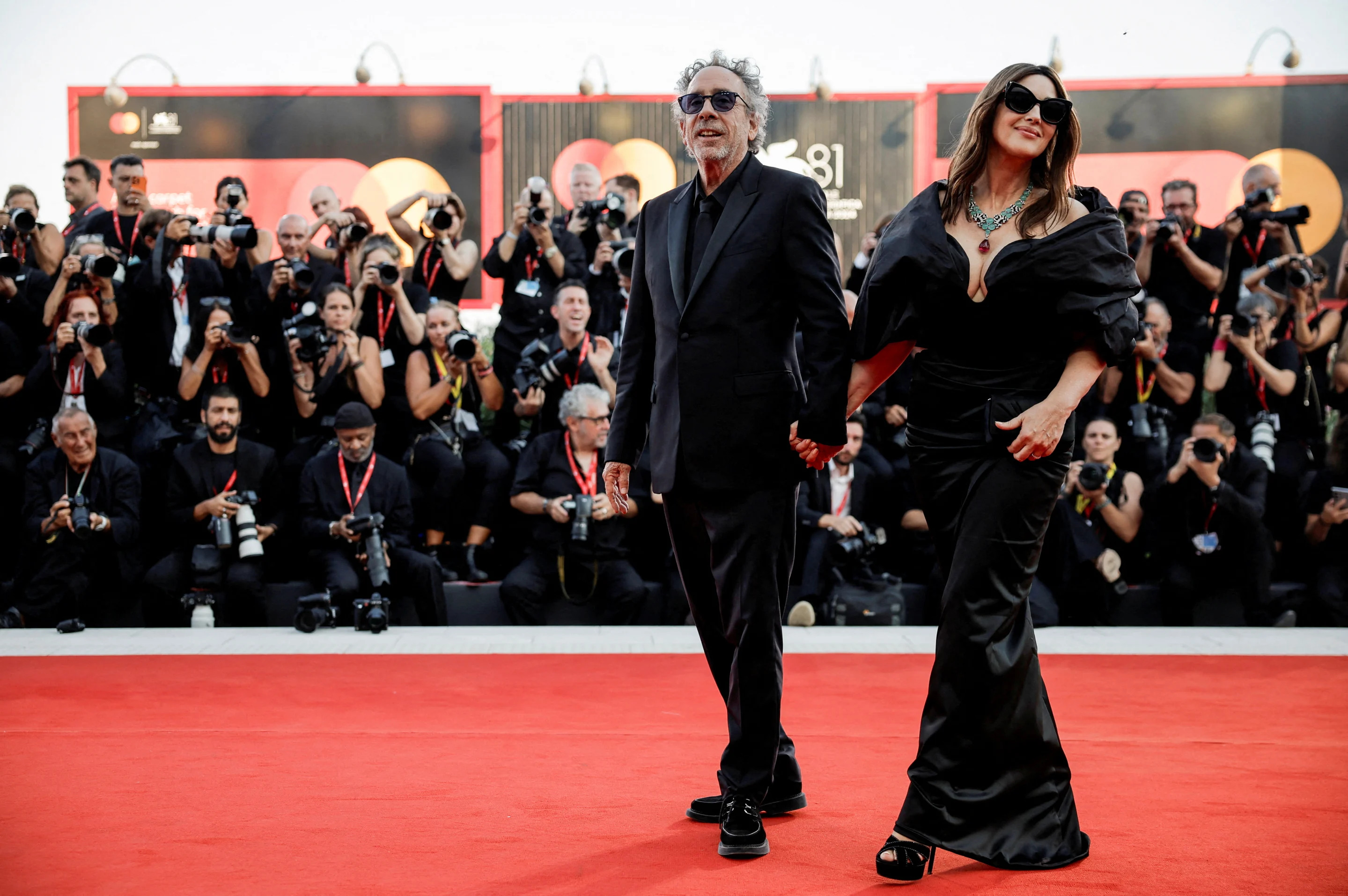 El director Tim Burton y la miembro del reparto Monica Bellucci posan en la alfombra roja durante la llegada a la proyección de la película «Beetlejuice Beetlejuice» fuera de concurso, durante el 81 Festival de Cine de Venecia, Venecia, Italia, 28 de agosto de 2024. REUTERS/Louisa Gouliamaki TPX IMÁGENES DEL DÍA