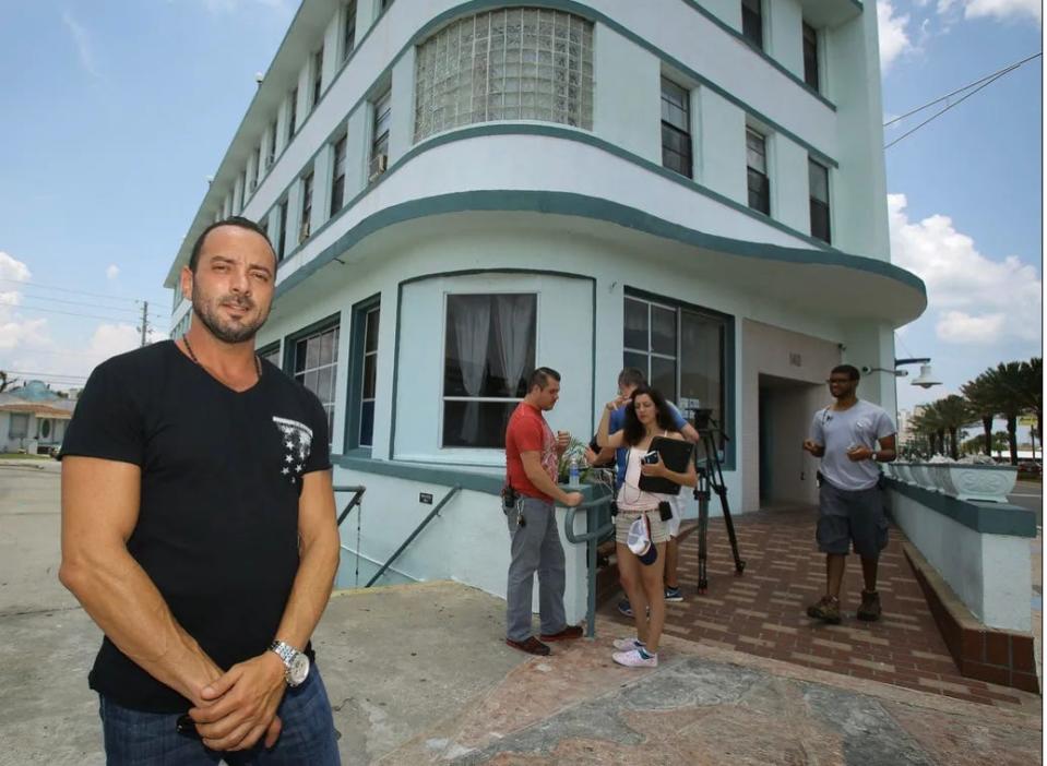 Streamline Hotel owner Eddie Hennessy stands in front of the hotel on June 21, 2014, when his efforts to renovate the "birthplace of NASCAR" are being filmed by a production crew from the Travel Channel's "Hotel Impossible" reality television show. The $6 million project to restore the 1940s-era art deco hotel in Daytona Beach was finally completed in May 2017.