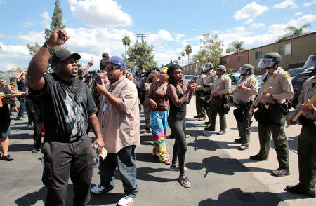 Protesters confront San Diego Sheriff's deputies near the site where an unarmed black man was fatally shot by police on Tuesday in El Cajon, California, U.S. September 28, 2016. REUTERS/Earnie Grafton