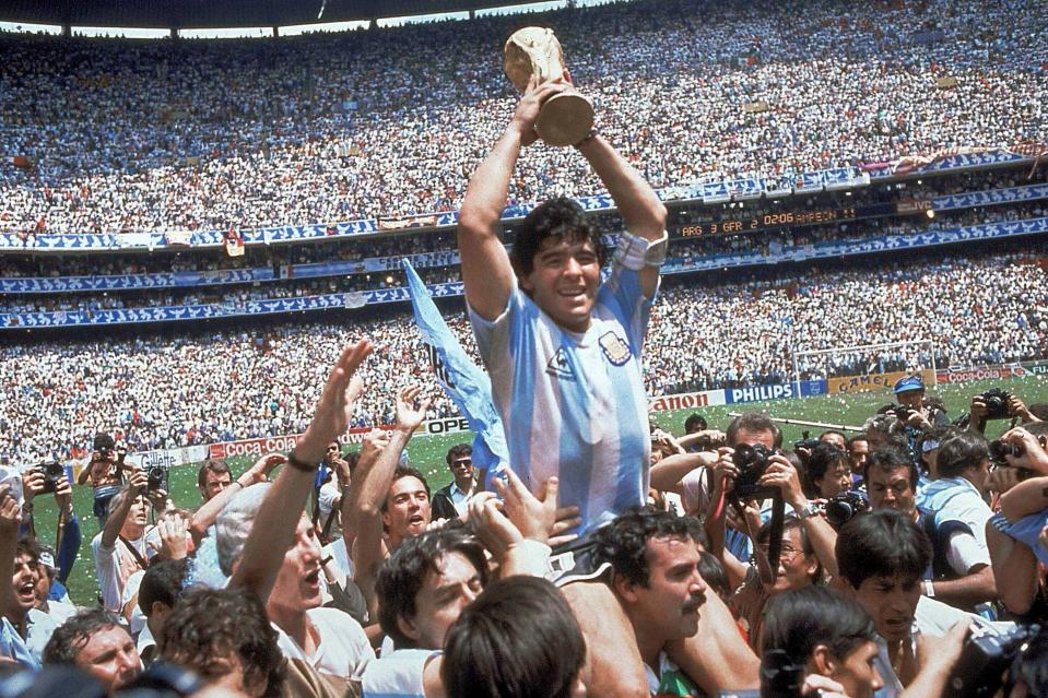 <p>Maradona holds up the World Cup after winning the 1986 final in Mexico</p> (AP)