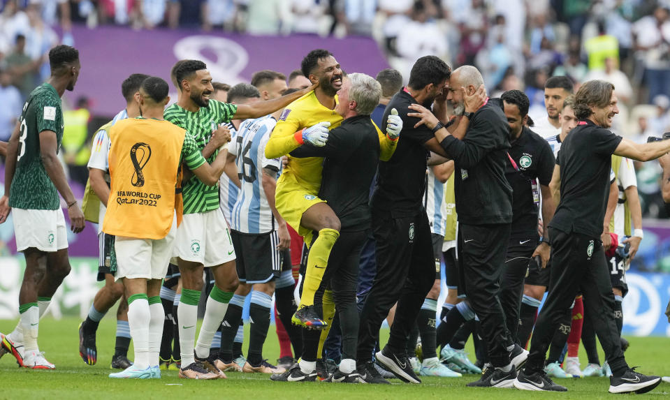 Saudi Arabia's goalkeeper Mohammed Al-Owais celebrates with his team after winning the World Cup group C soccer match between Argentina and Saudi Arabia at the Lusail Stadium in Lusail, Qatar, Tuesday, Nov. 22, 2022. (AP Photo/Natacha Pisarenko)