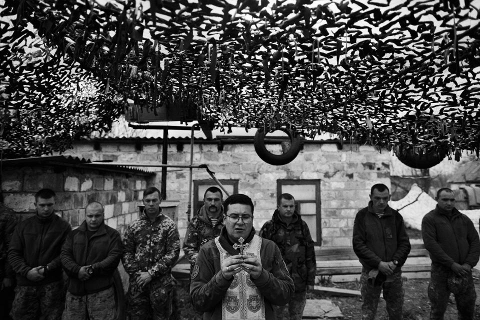 <p>A Ukrainian army priest conducts Mass during the celebration of Easter near the frontline in Piski, close to the Donetsk Airport, Ukraine, April 2017. (Photo: Manu Brabo/MeMo) </p>