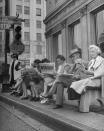 <p>A group of people waiting for the bus at the corner of Hollywood and Cahuenga Boulevards read about the D-Day invasion. <br></p>