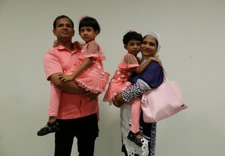 Kazi Mohammad, 40 and wife Arifa Afroz, 37, pose with their daughters Sanzida (2nd L), 6, and Shahzia, 5, in Hong Kong June 16, 2016, after they fled Bangladesh. REUTERS/Bobby Yip