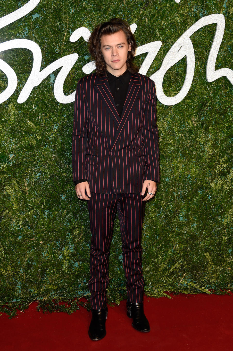 One Direction member Harry Styles, whose unique sense of style embodies British fashion for the boys, presented Emma Watson with the British Style Award. The singer wore a red-striped Lanvin suit.