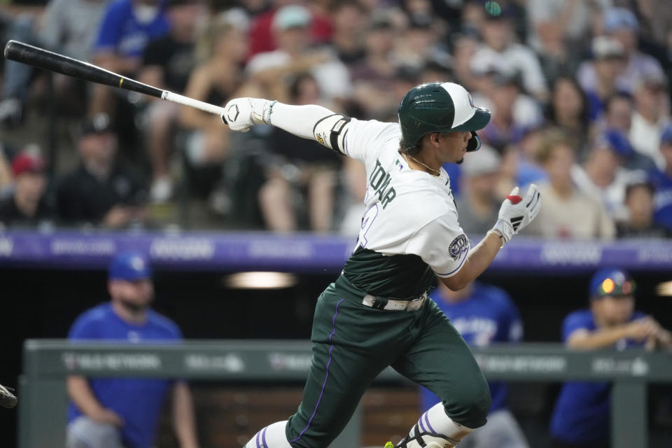 Colorado Rockies' Ezequiel Tovar watches his two-run double against the Toronto Blue Jays during the fourth inning of a baseball game Saturday, Sept. 2, 2023, in Denver. (AP Photo/David Zalubowski)