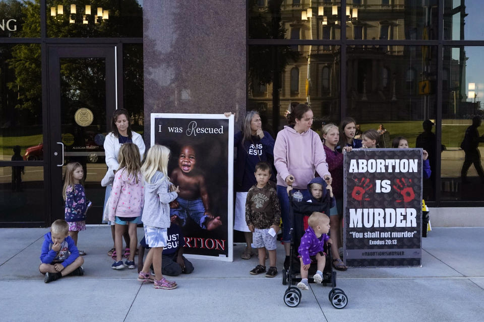 FILE - Abortion opponents are seen outside as the Michigan Board of State Canvassers meet during a hearing, Aug. 31, 2022, in Lansing, Mich. Abortion rights supporters won in the four states where access was on the ballot Tuesday, as voters enshrined it into the state constitution in battleground Michigan as well as blue California and Vermont and dealt a defeat to an anti-abortion measure in deep-red Kentucky. (AP Photo/Carlos Osorio, File)