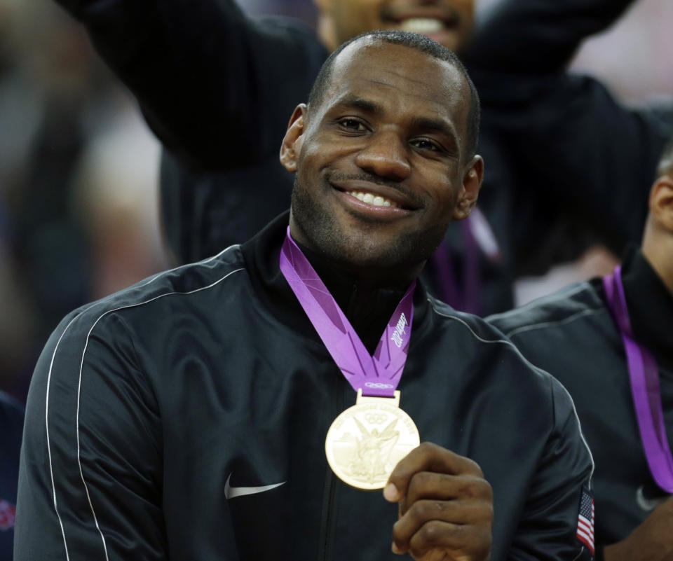 FILE - United States' LeBron James celebrates after winning the gold medal at the men's basketball game against Spain at the 2012 Summer Olympics, in London, Aug. 12, 2012. The NBA's all-time scoring leader seeks his third Olympic gold medal (2008, 2012) and returns to the Games for the first time in 12 years. At 39, James presumably is playing in his final Olympics. (AP Photo/Charles Krupa, File)