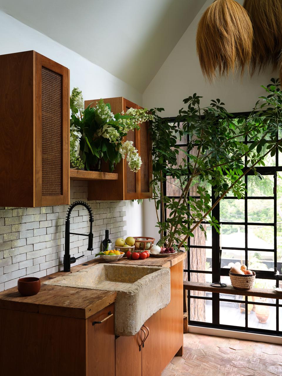 A 1,000-pound carved stone sink anchors James’s kitchen.