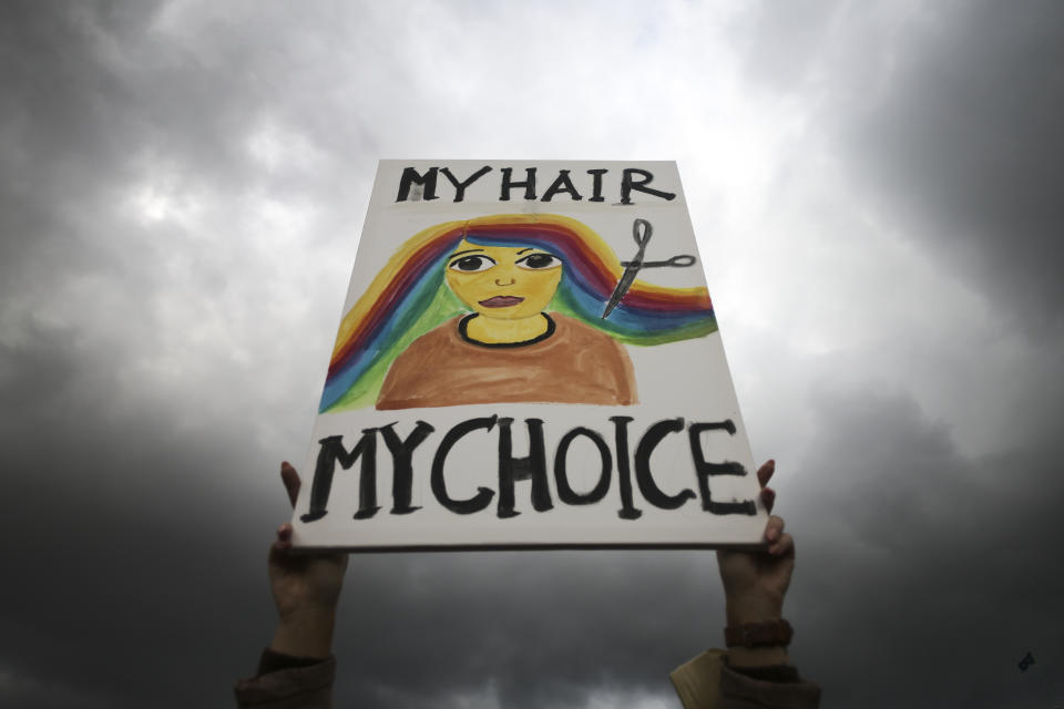 FILE - A woman holds a placard during a protest against the death of Iranian Mahsa Amini, in Berlin, Germany, Wednesday, Sept. 28, 2022. As anti-government protests roil cities and towns in Iran for a fourth week, sparked by the death of Amini, tens of thousands of Iranians living abroad have marched on the streets of Europe, North America and beyond in support of what many believe to be a watershed moment for their home country. (AP Photo/Markus Schreiber, File)