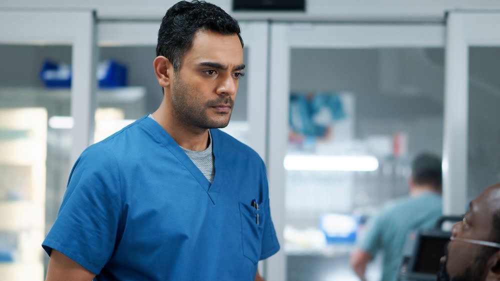  Hamza Haq as Dr. Bashir Hamed in blue scrubs in Transplant season 3. 