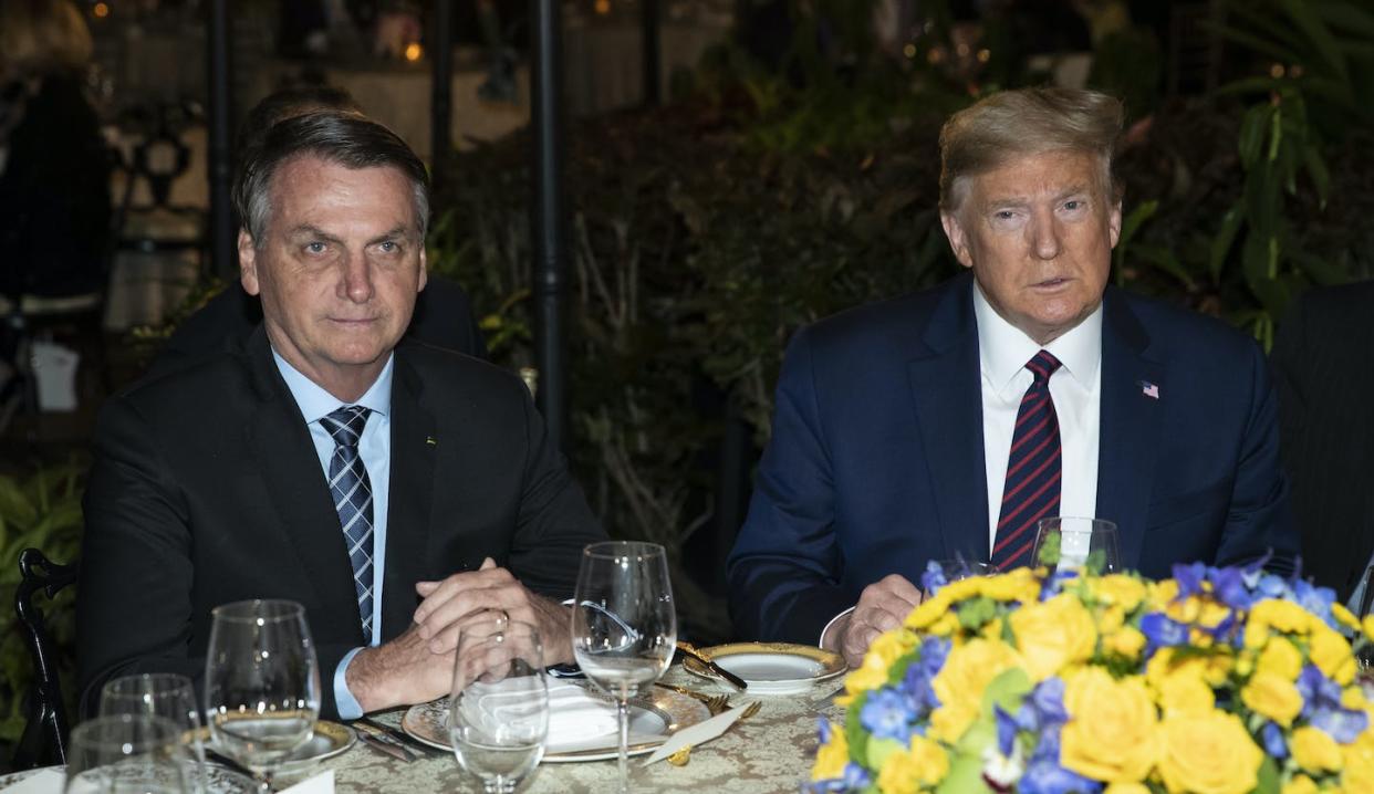 Donald Trump sits next to Jair Bolsonaro at Mar-a-Lago in Palm Beach, Fla., in March 2020, when both men led their countries. (AP Photo/Alex Brandon)