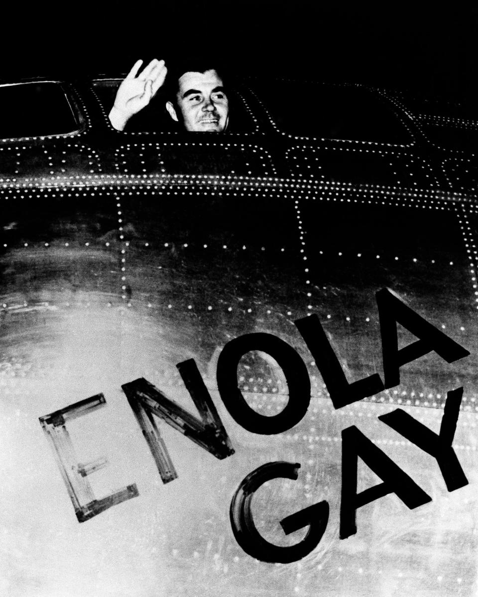 Col. Paul W. Tibbets, Jr., pilot of the Enola Gay, the plane that dropped the atomic bomb on Hiroshima, Japan, waves from his cockpit before takeoff from Tinian Island in Northern Marianas, Aug. 6, 1945.