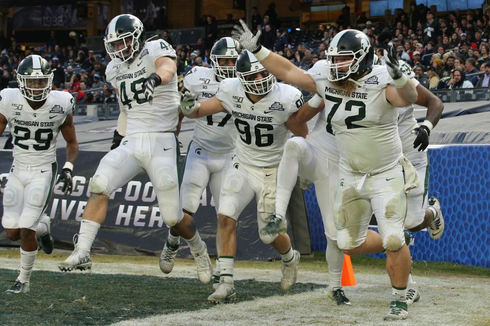 Michigan State defensive tackle Mike Panasiuk (72) celebrates his interception return for a touchdown against Wake Forest during the first quarter of the Pinstripe Bowl at Yankee Stadium, Dec. 27, 2019.