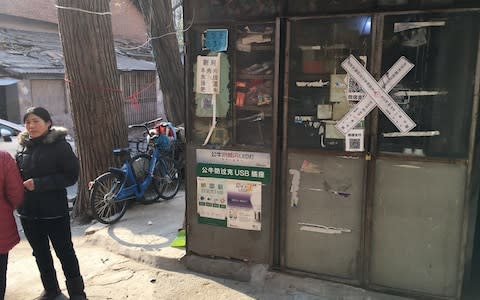 Mrs Wu has lived in Beijing for 18 years, but has been told to leave her home, the local shop - Credit: Neil Connor/Telegraph