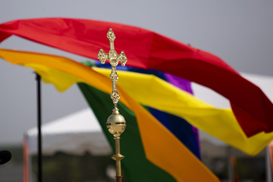 A cross from St. John's Episcopal Church is seen during a pride worship service at the Lynne Sherwood Waterfront Stadium in Grand Haven, Mich., on Saturday, June 10, 2023. The festival — which organizers had hoped would attract at least 500 attendees — drew thousands of people from all over who came to experience the first-time event's drag show, dance party and vendor-filled streets. (AP Photo/Kristen Norman)