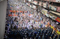 Supporters of Islami Andolan Bangladesh, an Islamist political party, face policemen during a protest against French President Emmanuel Macron and against the publishing of caricatures of the Prophet Muhammad they deem blasphemous, in Dhaka, Bangladesh, Tuesday, Oct. 27, 2020. Muslims in the Middle East and beyond on Monday called for boycotts of French products and for protests over the caricatures, but Macron has vowed his country will not back down from its secular ideals and defense of free speech. (AP Photo/Mahmud Hossain Opu)