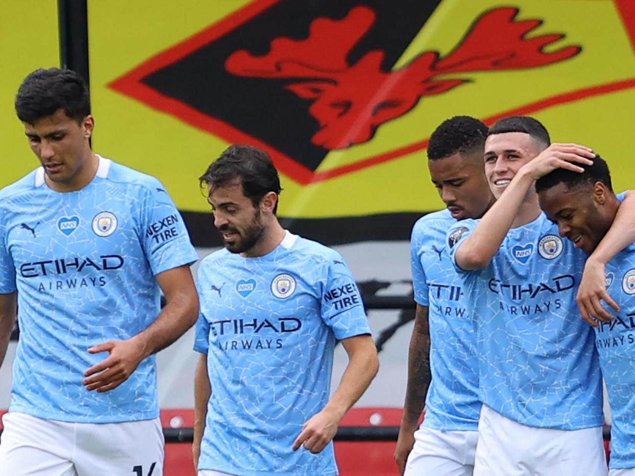 Manchester City players celebrate Sterling's second goal on Tuesday night: POOL